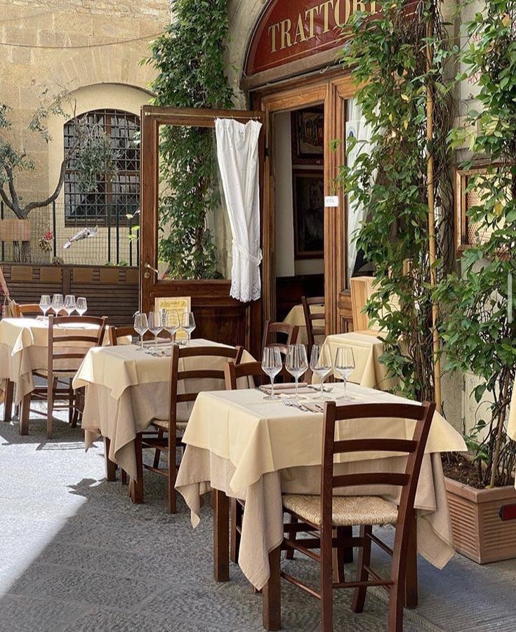 an outdoor dining area with tables and chairs