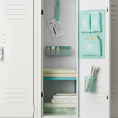 a white locker with some books and pens in it