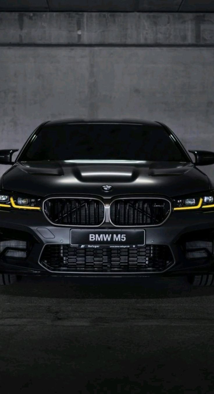 the front end of a black bmw m5