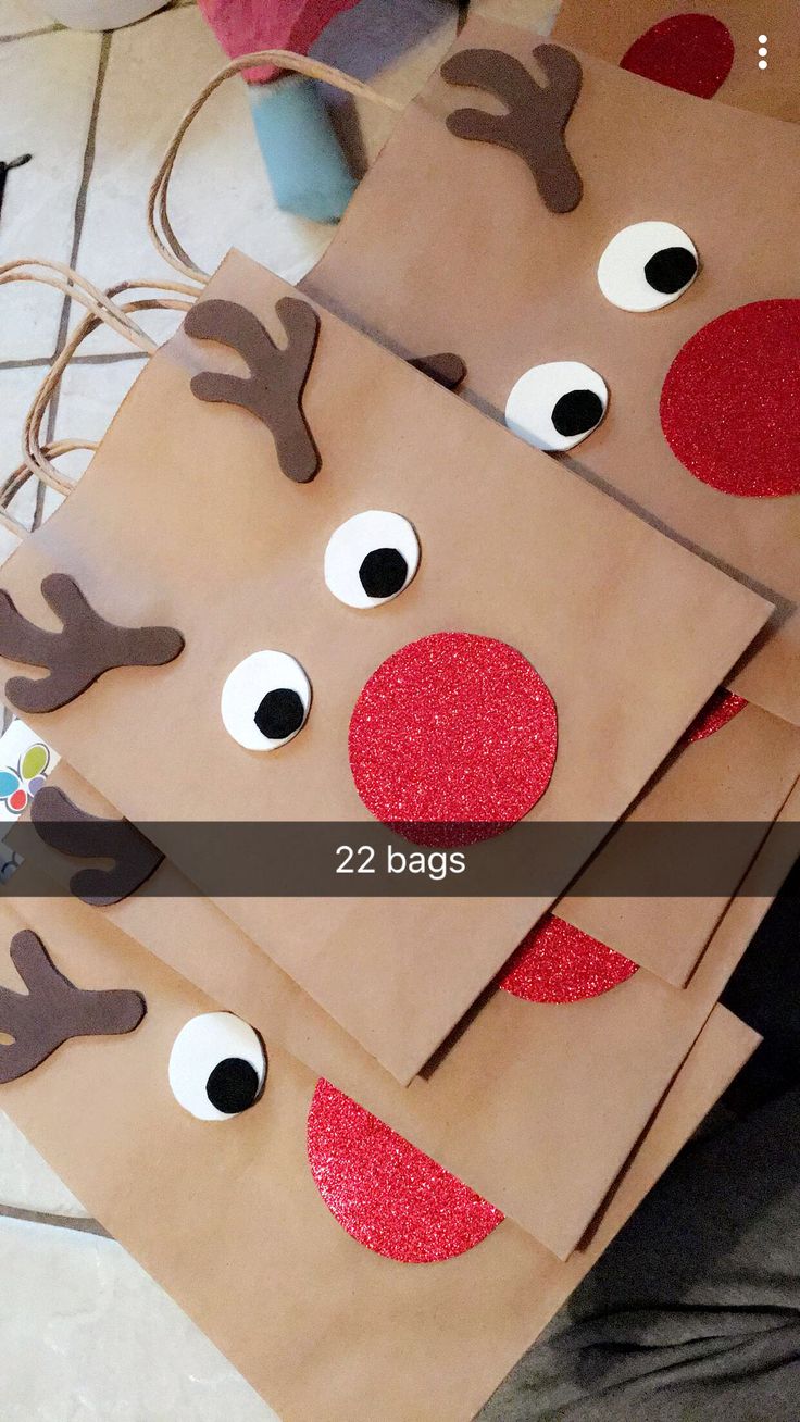 some brown paper bags with reindeer faces on them