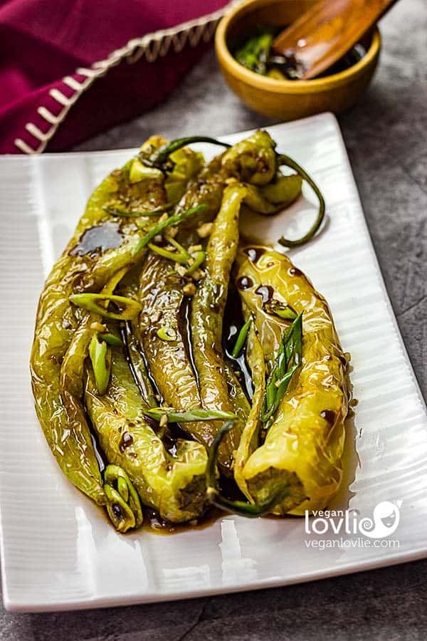 a white plate topped with cooked green peppers