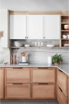 an image of a kitchen setting with white cabinets and marble counter tops on instagram