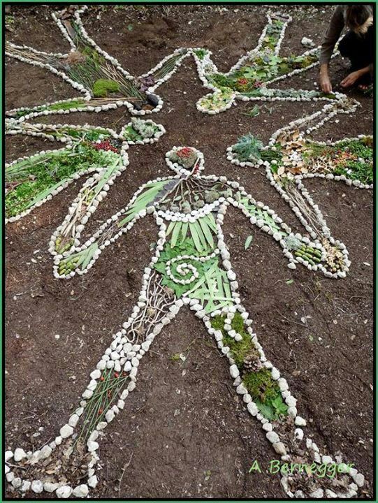 a man made out of shells and beads on the ground