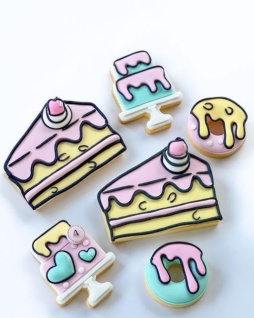 decorated cookies and pastries on a white surface