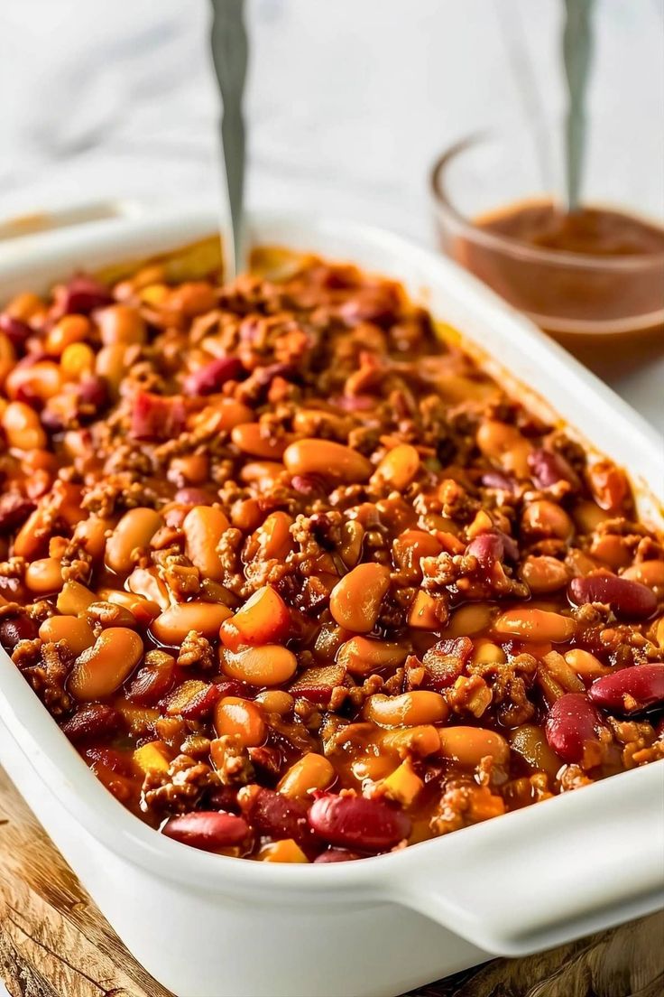 a casserole dish filled with beans and meat