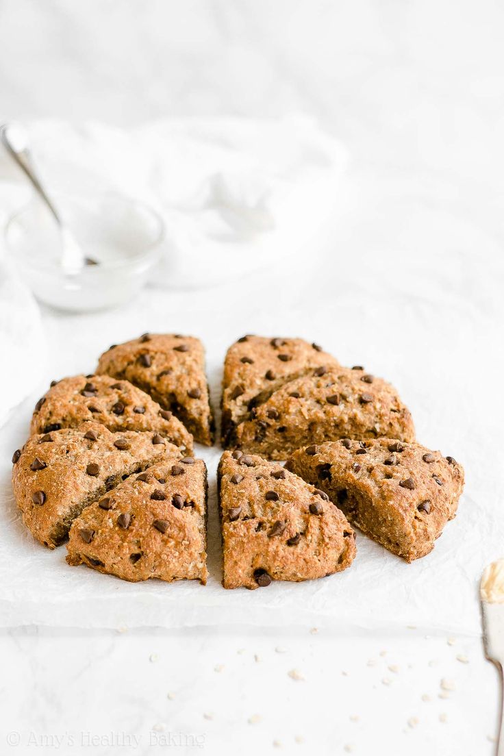 chocolate chip cookies arranged in a circle on top of a paper towel next to a spoon