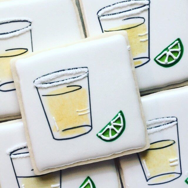 several decorated cookies with lemon slices and drinks on them are arranged in the shape of square tiles