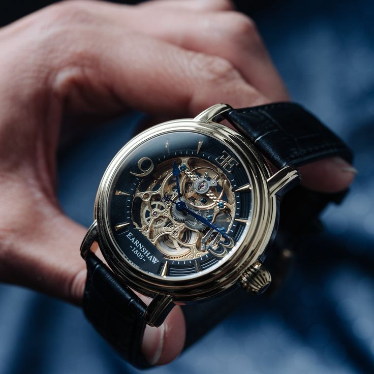 This three hand, automatic skeleton is a delightful aesthetic indulgence, with exposed mechanics and delicate yet lavish gems. Utter precision and care form the backbone of this timepiece. SPECIFICATIONS MOVEMENT: Automatic Skeleton 3 Hands with Open Heart CASE MATERIAL: Stainless Steel CASE DIAMETER (mm): 48 CASE THICKNESS (mm): 16 CASE COLOUR: Ionic Plating - Gold BAND: 22mm Black Genuine Leather Strap WATER RESISTANCE: 5 ATM WATCH WEIGHT (g): 100 Watch Winders, Big Watches, Three Hands, G Shock Watches, Classic Watches, Custom Watch, Leather Band, Gold Watch, Cool Watches