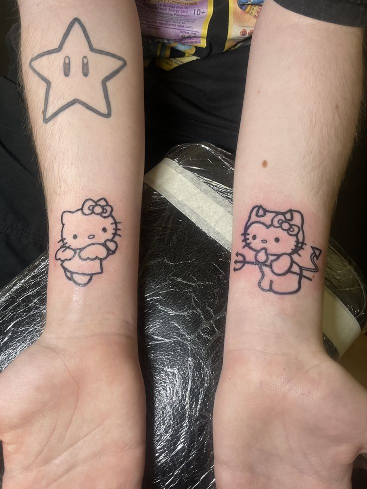 two people with matching tattoos on their arms, one has a hello kitty and the other has a star