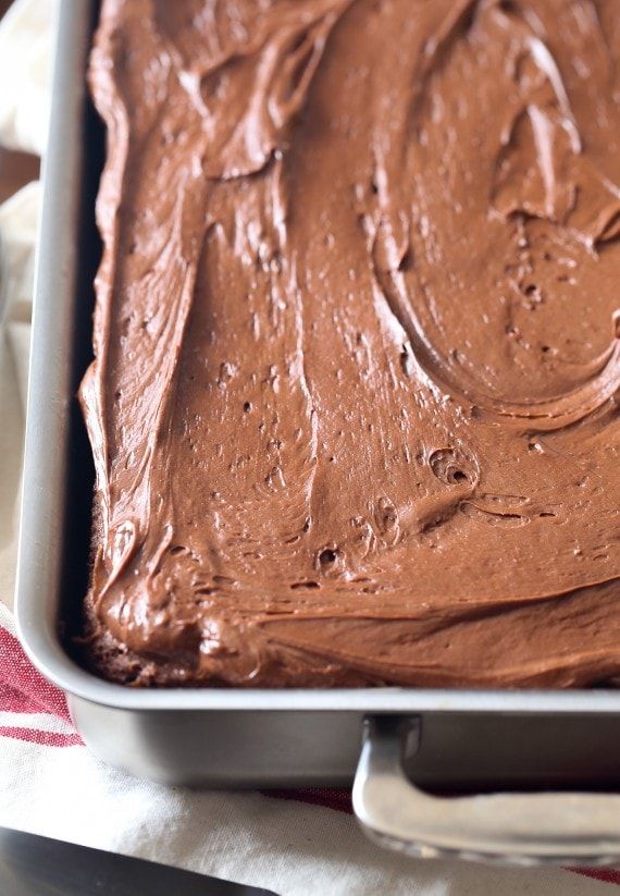 a pan filled with chocolate frosting on top of a table