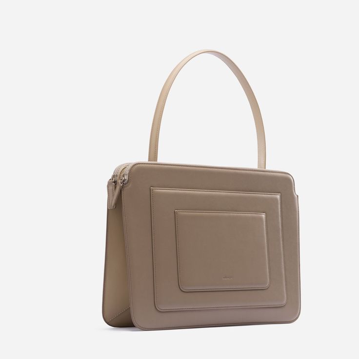 Designed in a silhouette inspired by Art-Deco style, this bag is expertly crafted from Italian calf leather with microsuede lining. Packs a ton of features in a slim, compact space so you can carry your office life in the bag — including a 16” Macbook Pro. It has additional two tight slots on the front that you can fit your notebook, phone or tablet. Crafted from Italian cow leather. Soft coating zippers ensure your laptop won't get scratched. h:28 X w:39.5 X d:7 cm (11 X 15.5 X 2.75 in) Handle Modern Laptop Bag With Removable Pouch, Modern Rectangular Laptop Bag With Removable Pouch, Modern Rectangular Laptop Bag With Detachable Handle, Modern Laptop Bag With Top Handle, Modern Rectangular Laptop Bag With Detachable Strap, Contemporary Bags With Top Handle And Removable Pouch, Contemporary Top Handle Bag With Removable Pouch, Modern Square Shoulder Bag For Business, Modern Business Box Bag