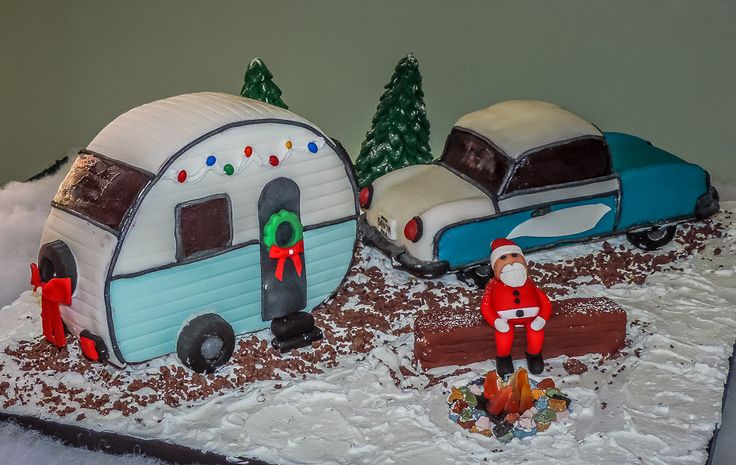 a cake made to look like a camper and trailer with santa clause on it