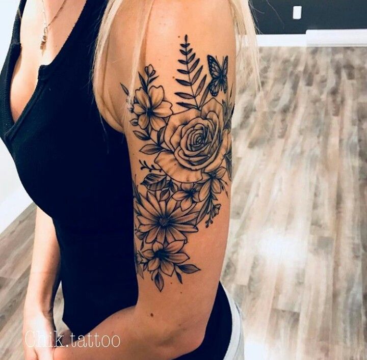 a woman with a flower tattoo on her arm