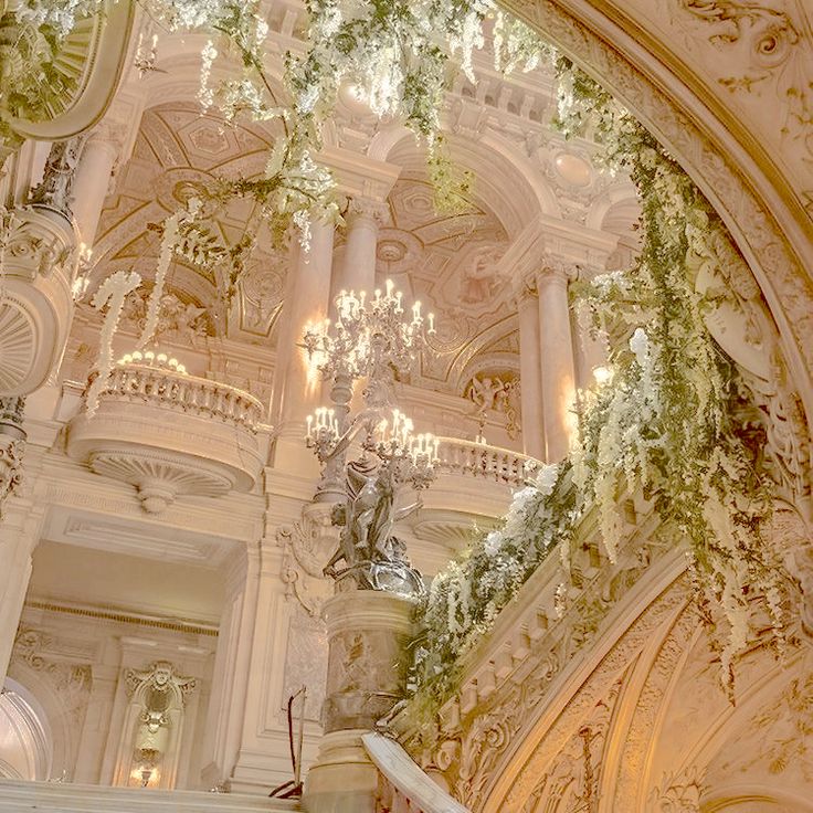 an ornate building with chandeliers and flowers on the ceiling