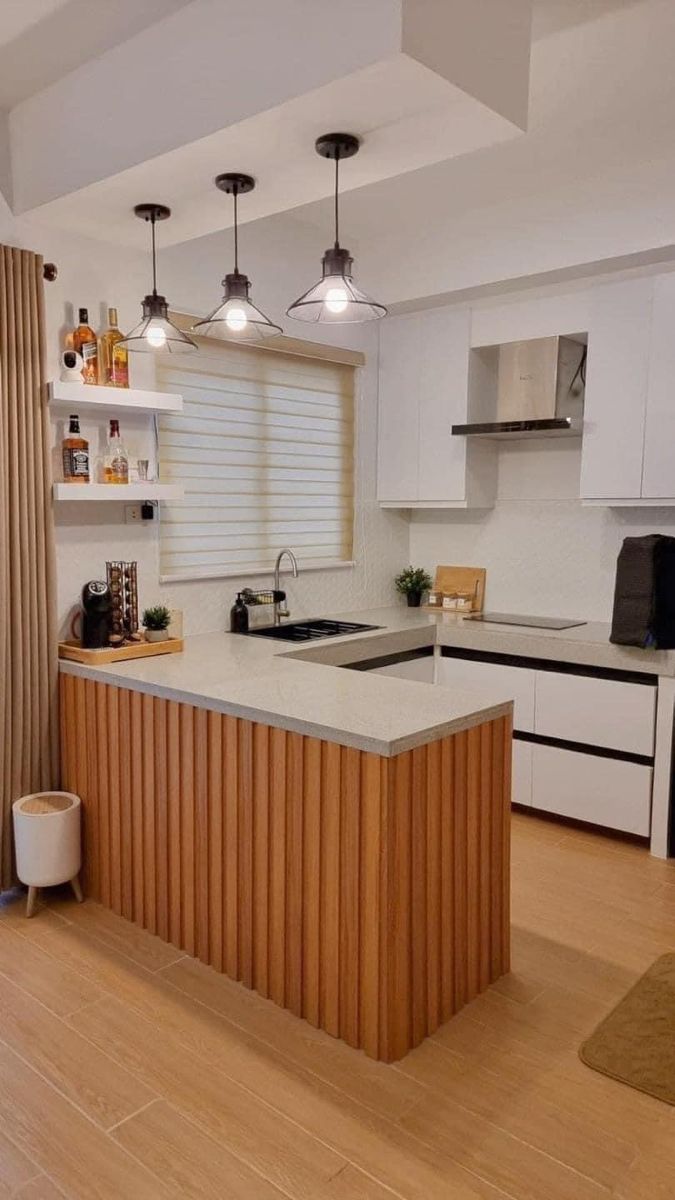 a kitchen with an island in the middle and lots of counter space next to it