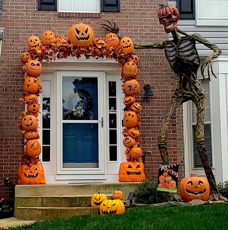 a house decorated for halloween with pumpkins and jack - o'- lantern decorations