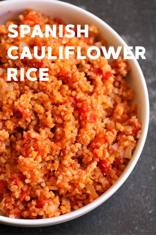 spanish cauliflower rice in a white bowl with the words, spanish cauliflower rice