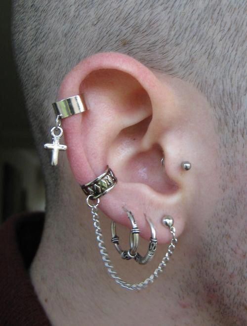 a man with ear piercings and chains around his ears