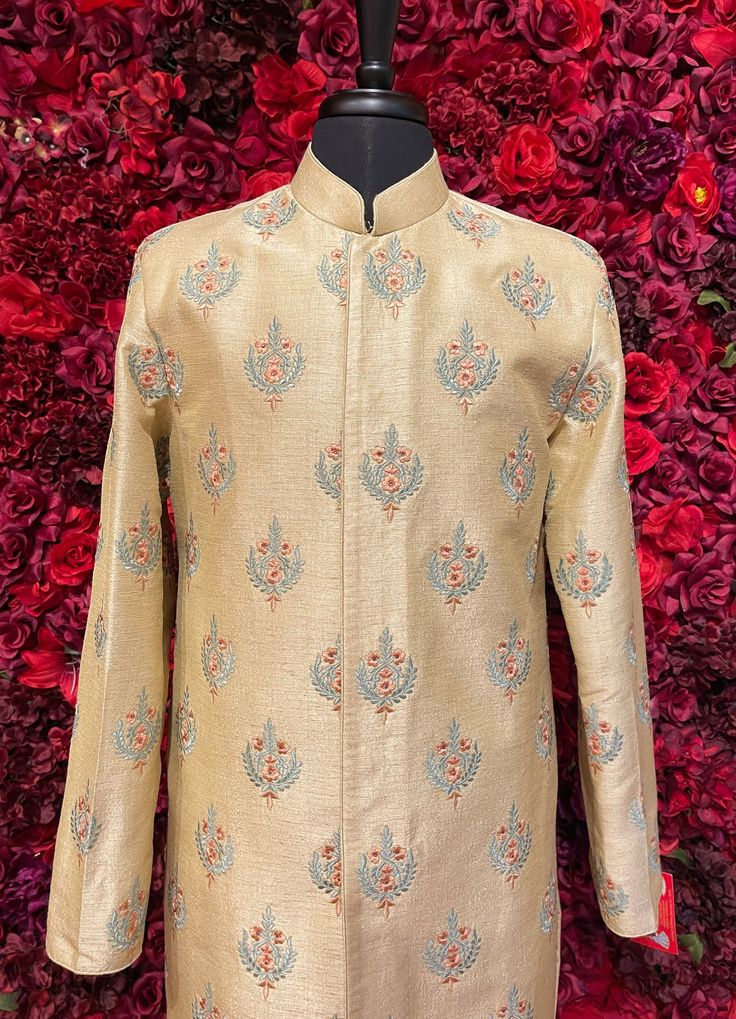 A regal golden sherwani with intricate embroidered details, perfect for grooms seeking a traditional yet majestic look. Key Features: Fabric: Premium brocade with intricate woven patterns Collar: High-neck design with subtle embellishments Buttons: Gold-toned embroidered buttons, adding a sophisticated finish Occasion: Ideal for weddings, receptions, and other grand occasions Color - Linen Off-White Designer Off White Kurta For Eid, Designer Off-white Kurta For Eid, Designer Off-white Bandhgala With Resham Embroidery, Designer Kurta For Reception And Transitional Seasons, Formal Off White Kurta With Cutdana, Formal Off-white Kurta With Cutdana, Designer Cream Kurta With Cutdana, Designer Off White Kurta With Resham Embroidery, Designer Festive Kurta With Stand Collar