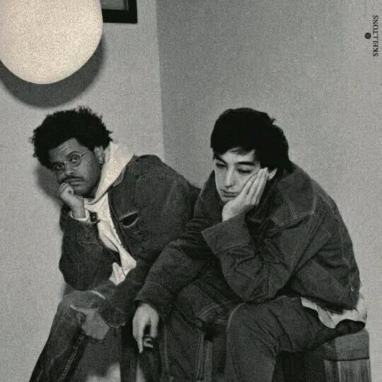 two young men sitting next to each other