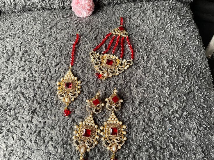 red wedding set. set includes tikka jhumar earrings Red Hand Set Jewelry For Festivals, Red Jewelry Sets For Diwali Gift, Red Chandbali Jewelry Sets For Diwali, Heavy Red Jewelry Sets For Diwali, Red Jewelry Sets For Diwali, Red Jewelry For Diwali Party, Bollywood Style Red Jewelry Set For Diwali, Festive Red Stone Work Jewelry Sets, Red Jewelry With Matching Earrings For Diwali