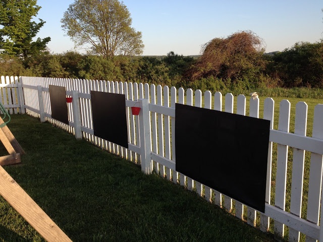 a white picket fence with chalkboards on it