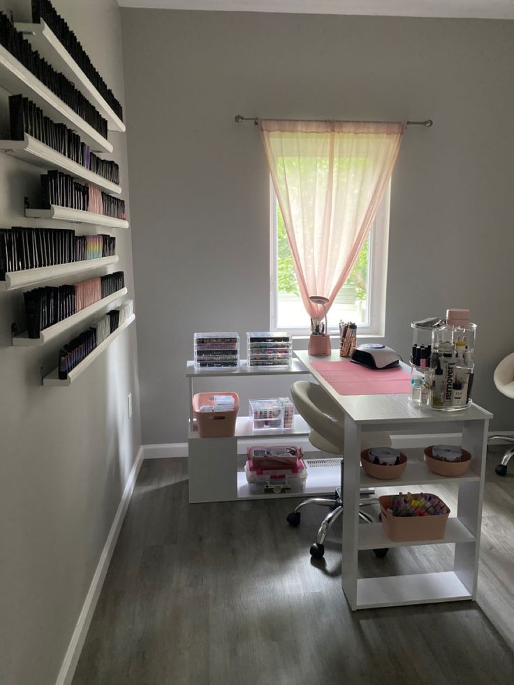 a room with some shelves on the wall and a desk in front of a window