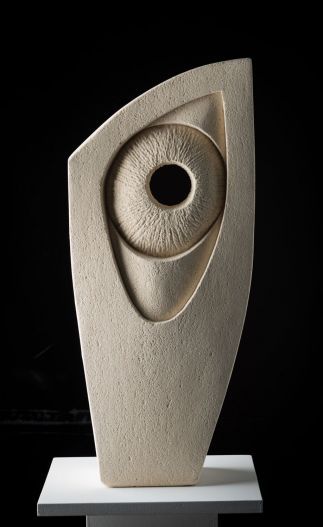 an abstract sculpture is displayed on a white pedestal in the dark room with black background