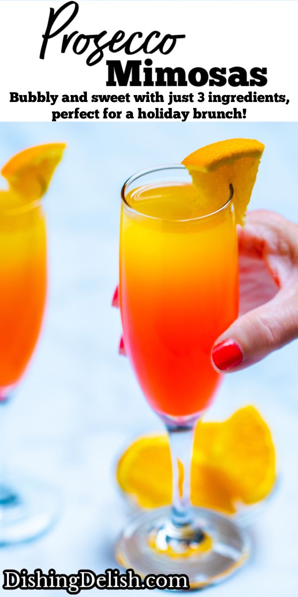 two glasses filled with orange juice and garnished with an orange slice