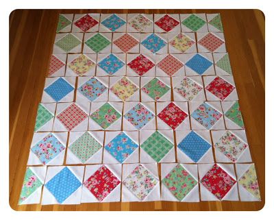 a patchwork table runner made from old quilts and fabric squares, on a wooden floor