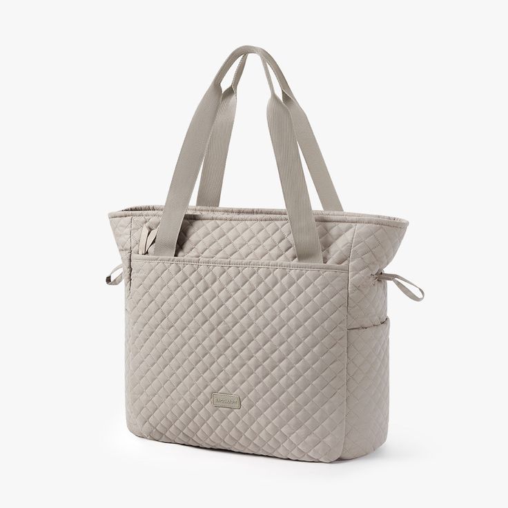 *The Wanderland Travel Tote is machine washable. Dimension: 41(L)x 16.5(W) x 37(H) cm/ 16.14 x 6.5 x 14.56 inch Weight: 500g/ 1.32lb 3D-Knit quilted surface Large opening design Consciously crafted with soft, water-resistant and durable polyester materials Exterior: A front zip compartment with two pockets and one pen slip; A back zip pocket; A bottom zip compartment Interior: A main zip compartment with two mesh pockets and one zip pocket; Comfortable top handle for maximum comfort when carryin Functional Quilted Bag For Everyday Use, Functional Quilted Everyday Bag, Quilted Rectangular Bag For Weekend Trips, Casual Quilted Shoulder Bag For Daily Use, Quilted Beige Shoulder Bag For Travel, Beige Quilted Shoulder Bag For Travel, Casual Quilted Travel Bag, Casual Nylon Diaper Bag For On-the-go, Casual Nylon Diaper Bag