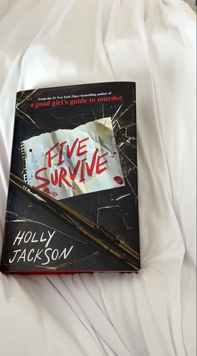 the book five survive is laying on top of a white bed sheet with a knife sticking out of it