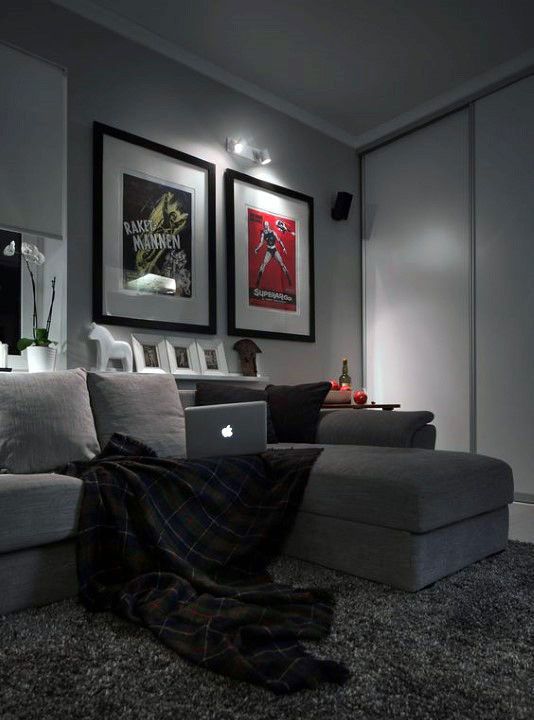 a living room filled with furniture and pictures on the wall next to a laptop computer