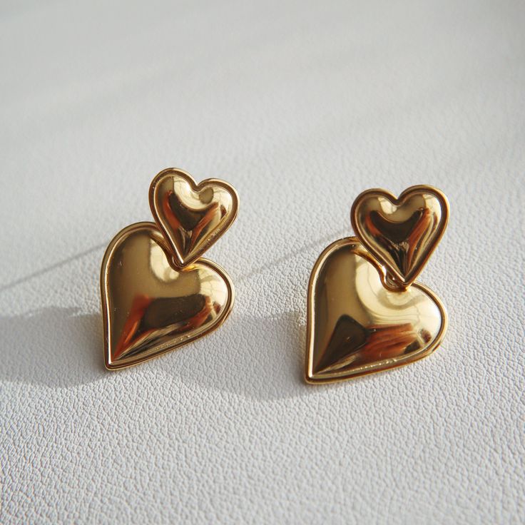 The Double Heart Drop Earrings will add a touch of love to any outfit. With their playful dangle design and bold heart shape, they're the perfect statement earrings for a girls night out or date night. Perfect for anyone who wants to show off their fun-loving side and spread lots of love wherever they go! - stainless steel, gold plated Heart Drop Earrings, Double Heart, Fun Loving, Lots Of Love, Girls Night Out, Heart Shape, Girls Night, Statement Earrings, Date Night