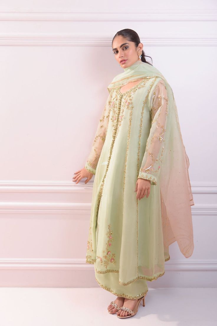 An alluring three piece on pastel green organza in an open kalidaar silhoute heavily embellished with gold zardosi hand craftmenship alongside resham French knots. Styled with a dreamy tye dye pure organza dupatta and embellished silk flappers. Stand out from the crowd in “ Mint Ballet “ Order Duration: 4 to 6 weeks Punjabi Dress Design, Heavy Dupatta, Embroidery Fashion Detail, Designer Kurti Patterns, Punjabi Dress, Pakistani Dresses Casual, Salwar Kamiz, Sleeves Designs For Dresses, Simple Pakistani Dresses