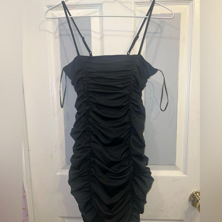 Not Fashion Nova Brand Size M Very Stretchy No Tags But Never Worn Before Smoke Free & Pet Free Home Black Stretch Dresses With Drawstring, Black Mini Dress With Ruched Sides For Spring, Black Mini Dress With Ruched Sides For Night Out, Black Drawstring Dress For Party, Black Drawstring Dress For Night Out, Black Stretch Dresses With Ruched Sides, Black Stretch Dress With Ruched Sides, Black Stretch Dress With Drawstring, Black Mini Dress With Ruched Sides For Date Night