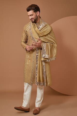 Beige silk kurta with mirror work. Comes along with a stole with mirror work border.
Components: 2
Pattern: Embroidery
Type Of Work: Mirror
Neckline: Stand Collar
Sleeve Type: Full Sleeves
Fabric: Silk
Color: Beige
Other Details: 
Note: Pant worn by the model is not for sale
Occasion: Sangeet - Aza Fashions Sangeet Outfit For Men, Stole For Men, Indian Wedding Clothes For Men, Sherwani For Men Wedding, Wedding Kurta For Men, Embroidery Mirror, Sangeet Outfit, Gents Kurta Design, Men Fashion Photo