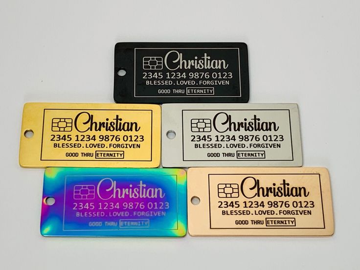 four different colored luggage tags on a white surface with the name christian printed on them