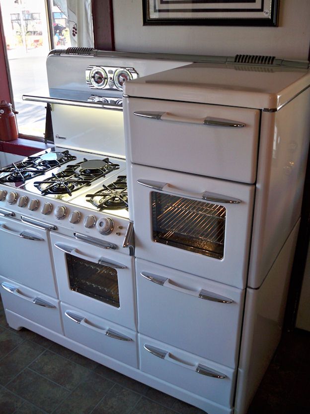 an old fashioned white stove and oven in a kitchen