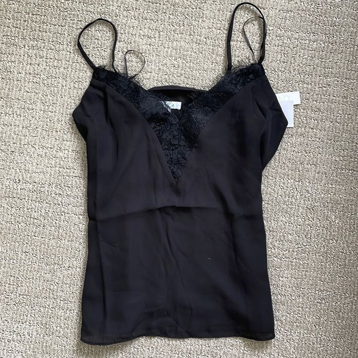 *New With Tags* Cute Polyester Black Tank Top With Lace V-Neck. Spaghetti Strap Black Lace Trim Spaghetti Strap Camisole, Elegant Black V-neck Camisole, Casual Lace Trim Camisole For Night Out, Chic Black V-neck Tank Top, Black Fitted V-neck Camisole, Black V-neck Camisole For Party, Black V-neck Party Camisole, Black V-neck Camisole For Evening, Black Lace Trim Camisole For Date Night