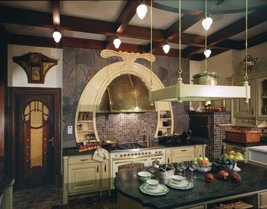 a large kitchen with lots of counter space and lights hanging from the ceiling above it