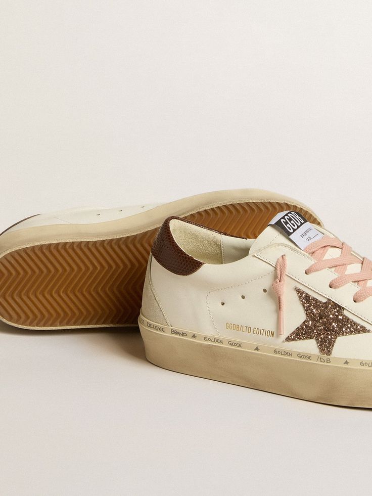 Double height and iconic design: inspired by our Super-Star sneakers, the Hi Star sneakers feature double foxing, embellished with hand lettering. This white leather model features a peach glitter star and brown lizard-print leather heel tab. The ice-gray suede insert on the back and pink laces add the finishing touch. Golden Family, Lizard Print, Double Height, Lace Socks, Pink And Brown, Glitter Stars, Star Sneakers, Super Star, Gray Suede