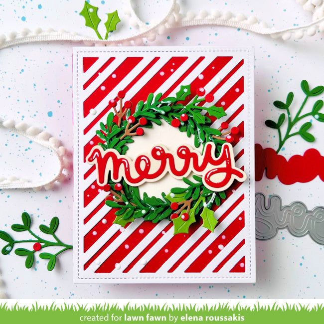 a christmas card with the word merry written in red and green on it, surrounded by holly