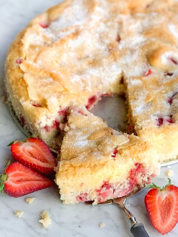 a close up of a cake on a plate with strawberries