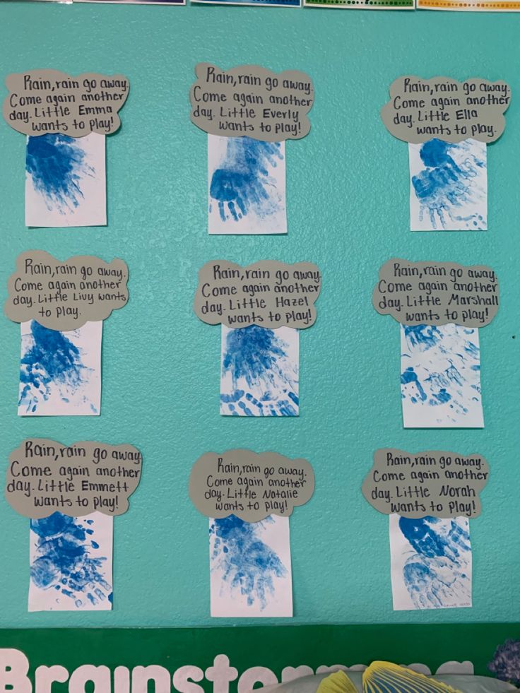 a bulletin board with blue handprints on it and words written in different languages