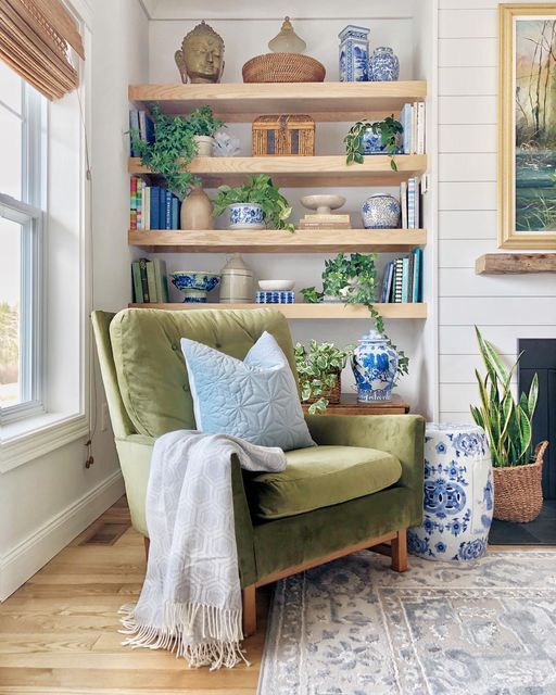 an instagram page with a green chair and potted plants on the shelf above it