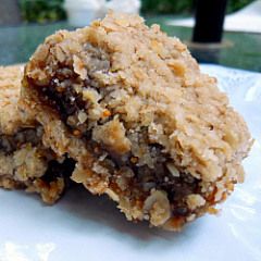 two oatmeal cookies sitting on top of a white plate next to each other