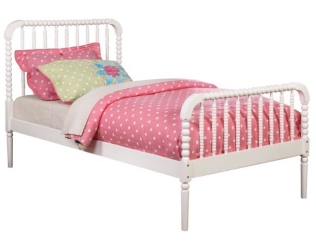 a small white bed with pink and green pillows on it's headrests