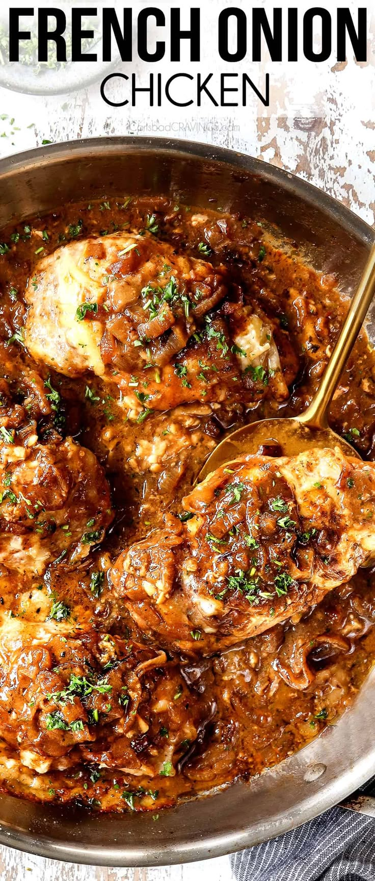 a pan filled with chicken covered in gravy and garnished with parsley