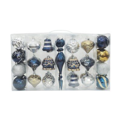 christmas ornament assortment in clear box with blue and silver ornaments on white background